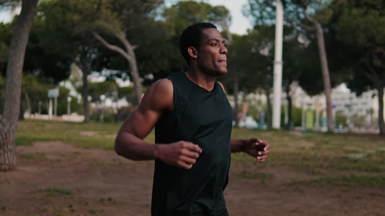 Young Athletic Black Man Warms Up In Park