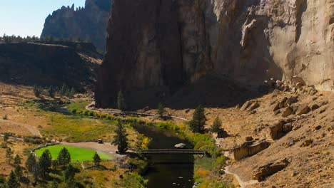 large spire reveal in smith rock state park, drone pull back, oregon