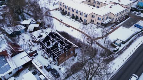 fire-burned-house-in-village,-winter-Snow