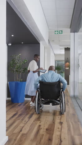 vertical video of african american business people with disabled man talking in slow motion