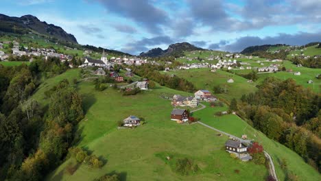 aerial push in toward picturesque swiss village on mountainside
