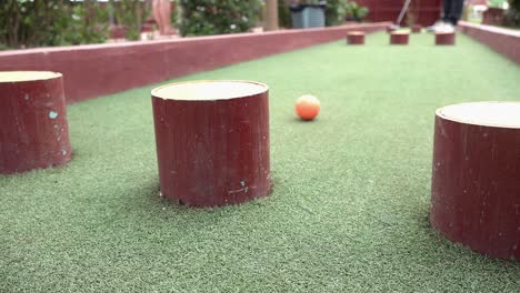 trying to avoid obstacles at the mini golf