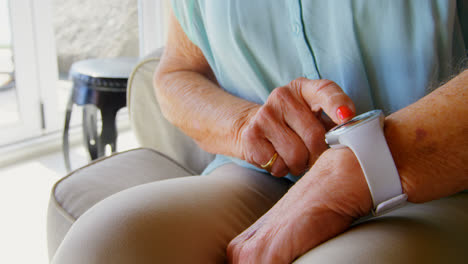 Mid-section-of-old-Caucasian-senior-woman-using-smartwatch-4k