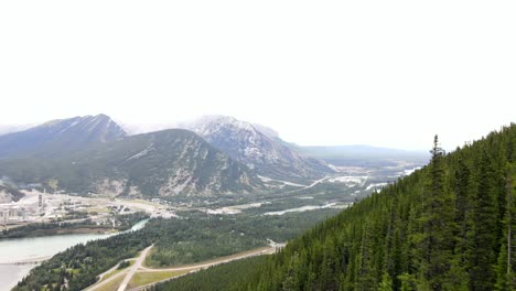 4k-cinematic-drone-passing-steep-rocky-slopes-and-coniferous-forests-closely