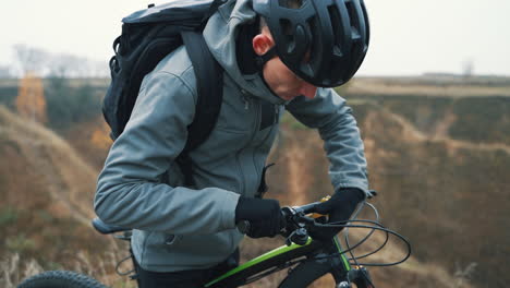 male cyclist adjusting the brakes of the mountain bike