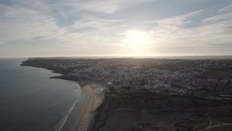 Top-view-over-fishing-village-of-Praia-da-Luz-at-dusk,-Algarve