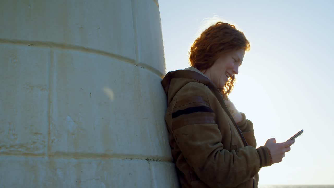 Woman using mobile phone at dock 4k