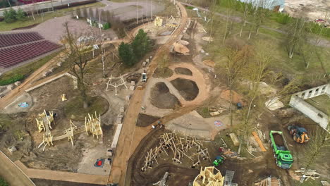 workers renovating park in europe city, aerial drone view