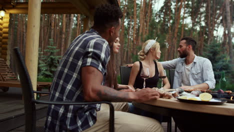 relaxed friends spending time together on backyard. fellows preparing food