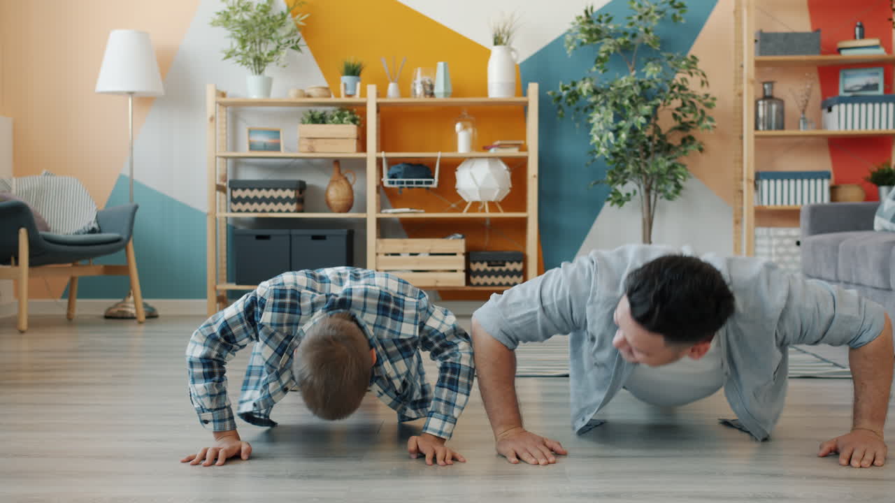Father and son doing push-ups at home