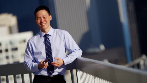 portrait of asian businessman using wifi on rooftop