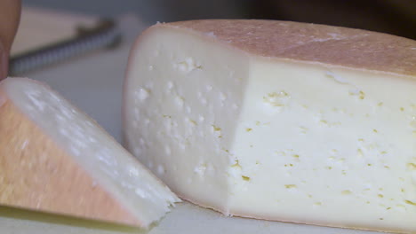 close-up of a sliced wheel of cheese