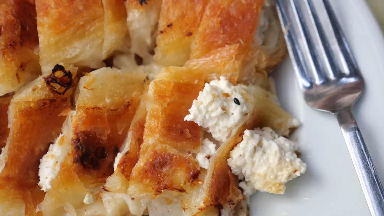 Close-up of golden brown baked burek with cheese
