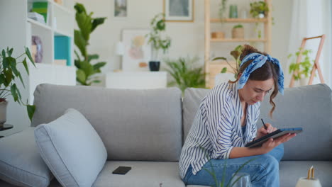 creative female student working on digital tablet