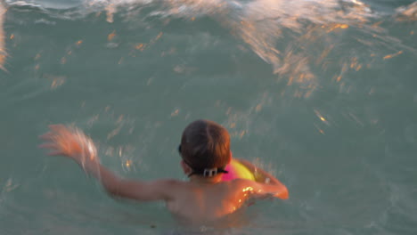 Child-bathing-in-the-sea-and-catching-strong-waves