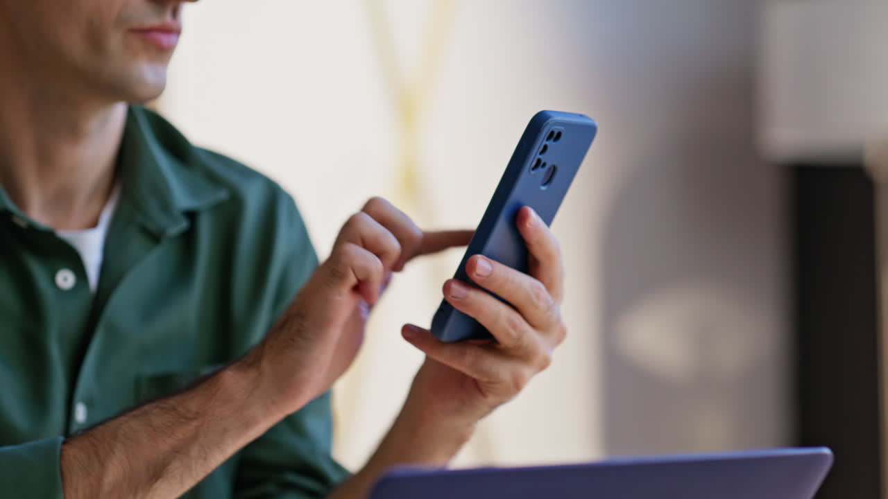 Millennial browsing mobile app for business time management at office closeup