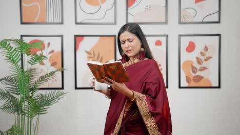 indian woman reading book with coffee