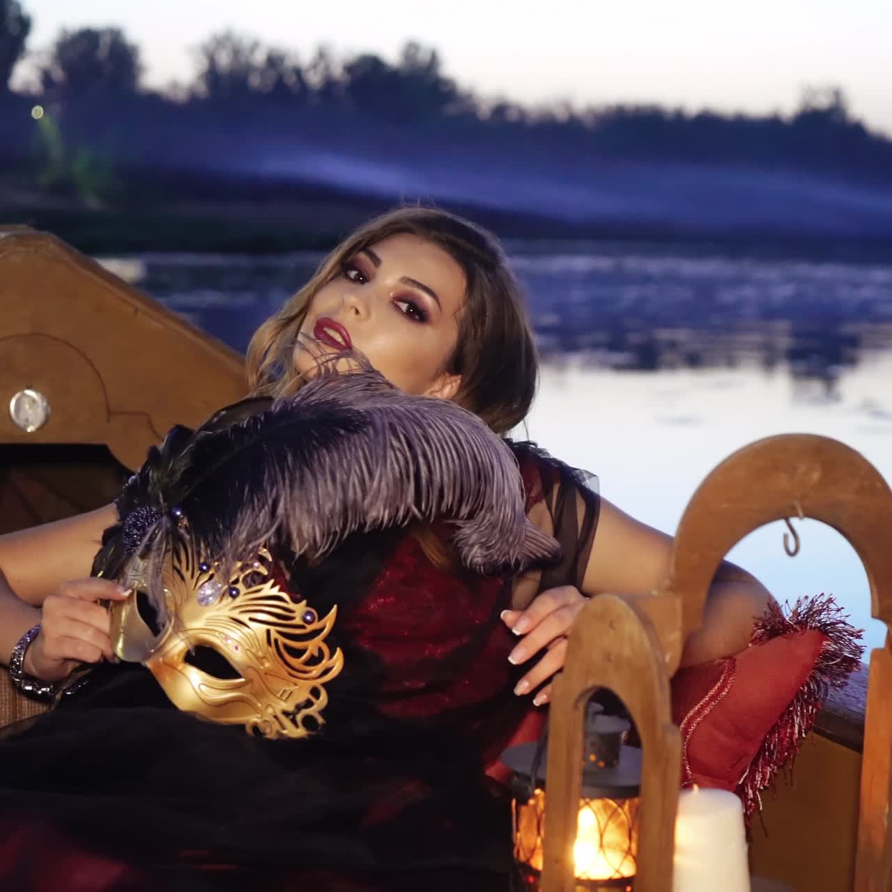Beautiful woman with carnival mask riding on gondola. Concept of female beauty, rest in the nature, and water travel.