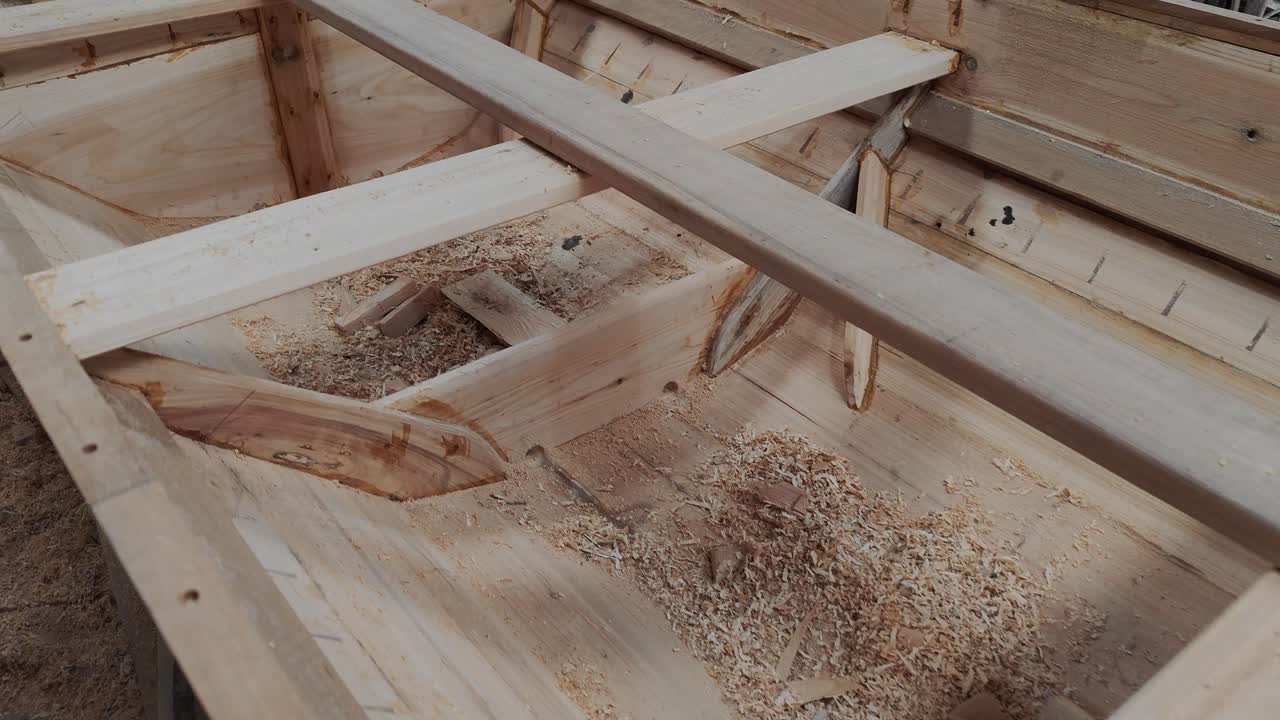 interior inacabado del casco de barco dragón de madera con herramientas de artesanía en el interior