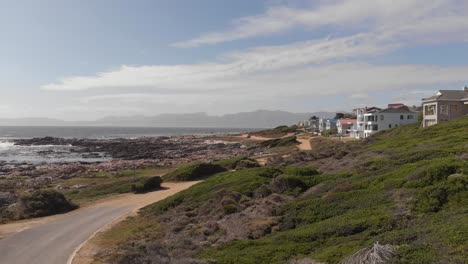 aerial: sea view houses of small south african valley at the garden route