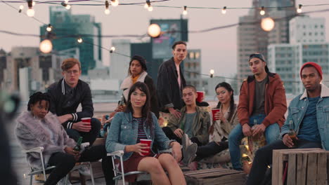 multi ethnic group of friends posing for photo on rooftop party at sunset students enjoying weekend gathering in urban city