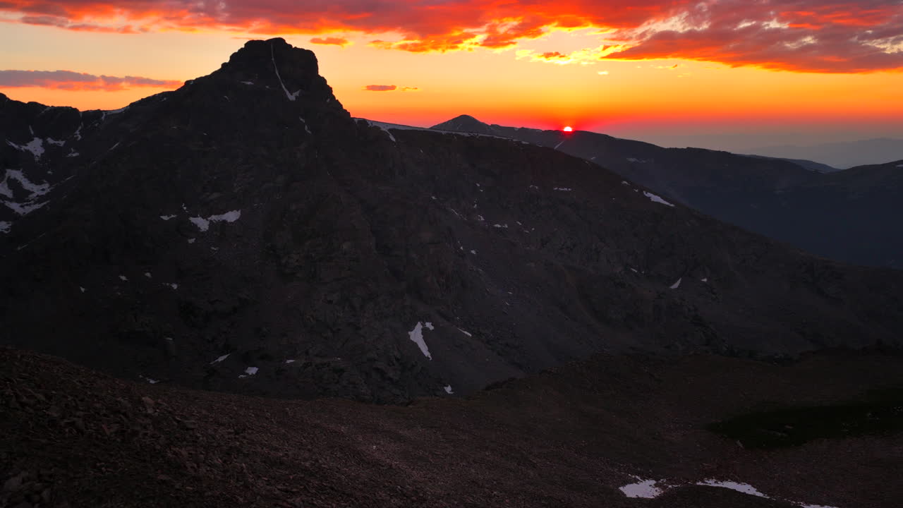 Mount of the Holy Cross Colorado 14er peak Sawatch Range aerial drone Vail Minturn Halo Ridge golden hour vibrant sunset on Rocky Mountains horizon Notch Mountain shelter circle left pan up motion