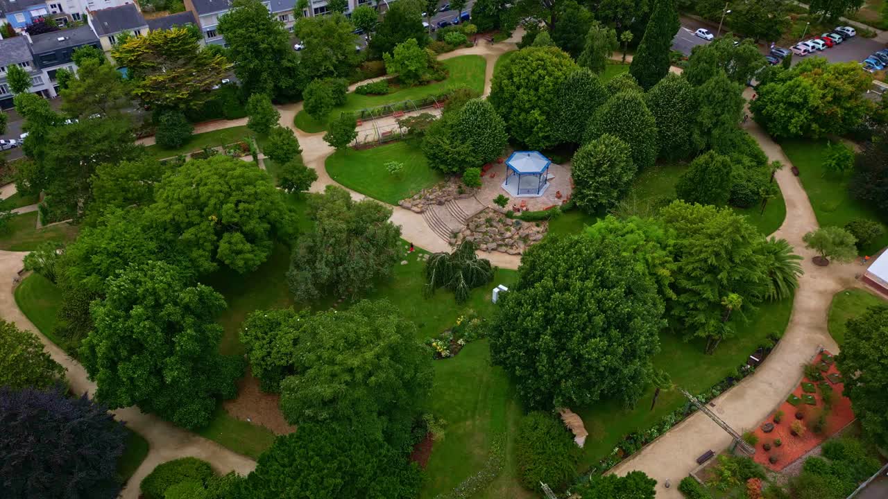 Descending drone movement to the new blue kiosk in Botanical Garden aka Jardin des Plantes, Saint-Nazaire, Loire-Atlantique, France