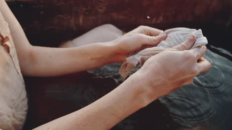 Woman-Cleaning-Skin-in-Dirty-Bath-in-Dystopian-World