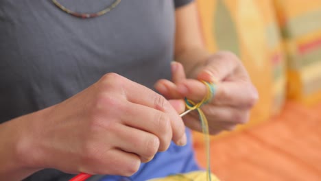 knitting handmade bracelet with the colors of ukrainian flag as a sign of solidarity with ukraine