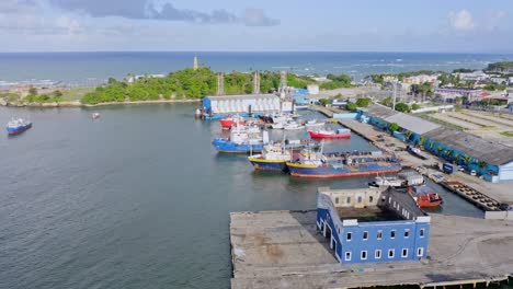 aerial flyover fishing and freight port with docking ships in puerto plata,dominican republic