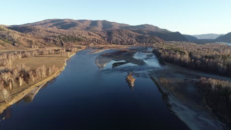 aerial view of a river winding through a mountain landscape