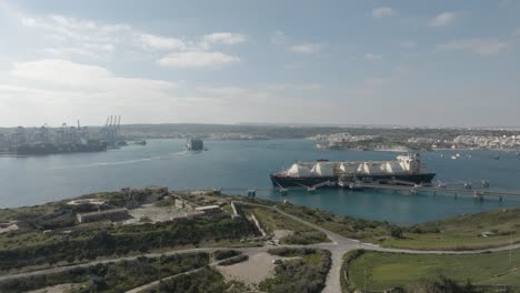 aerial drone shot from kalanka bay malta towards a gas tank ship in birzebbugia