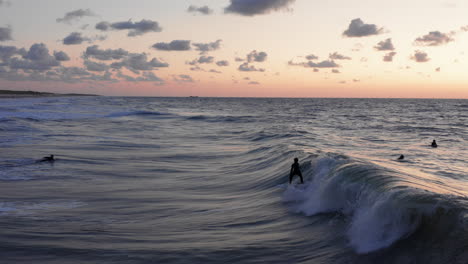 Surfers-in-front-of-the-touristic-town-Domburg-in-the-Netherlands-during-sunset