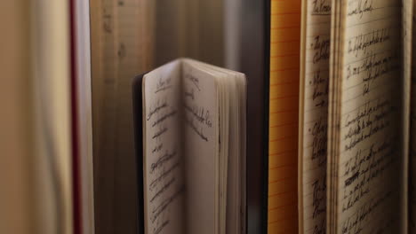 handheld moving close-up shot of old notebooks