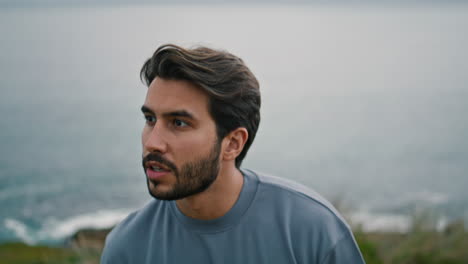 Bearded-man-walking-gloomy-sea-shore-alone-close-up.-Handsome-guy-enjoy-weekend.