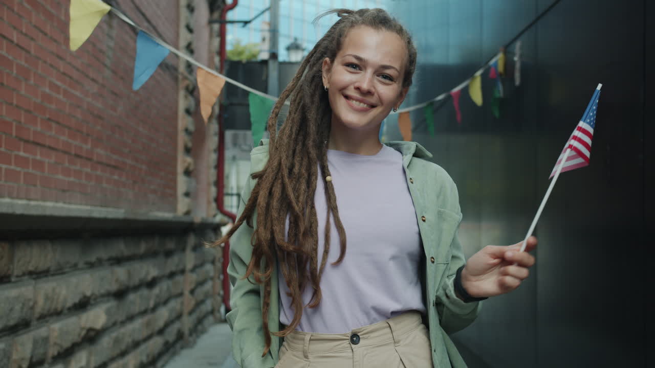 Happy Woman Celebrating in a City Street with an American Flag
