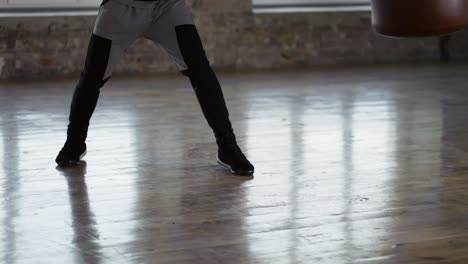 cropped view of a boxer s legs - man training at boxing studio in gloves at loft studio