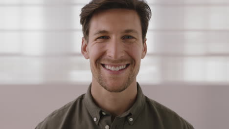 close-up-portrait-of-handsome-young-man-smiling-happy-looking-at-camera