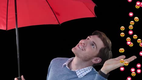 digital animation of multiple emojis falling over portrait of caucasian man holding an umbrella