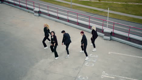 High-view-of-girl-group-performing-on-building-top