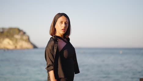 Attractive-brunette-enjoy-evening-sunlight-near-beach-at-Mallorca