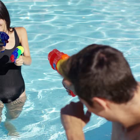 adults shooting shooting water guns at each other