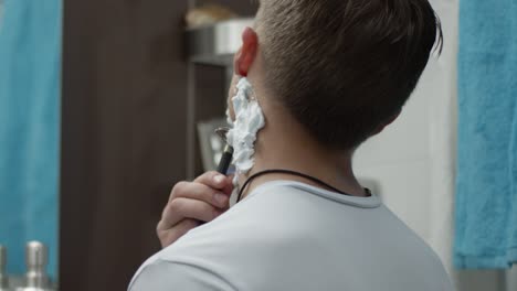 man shaving his neck