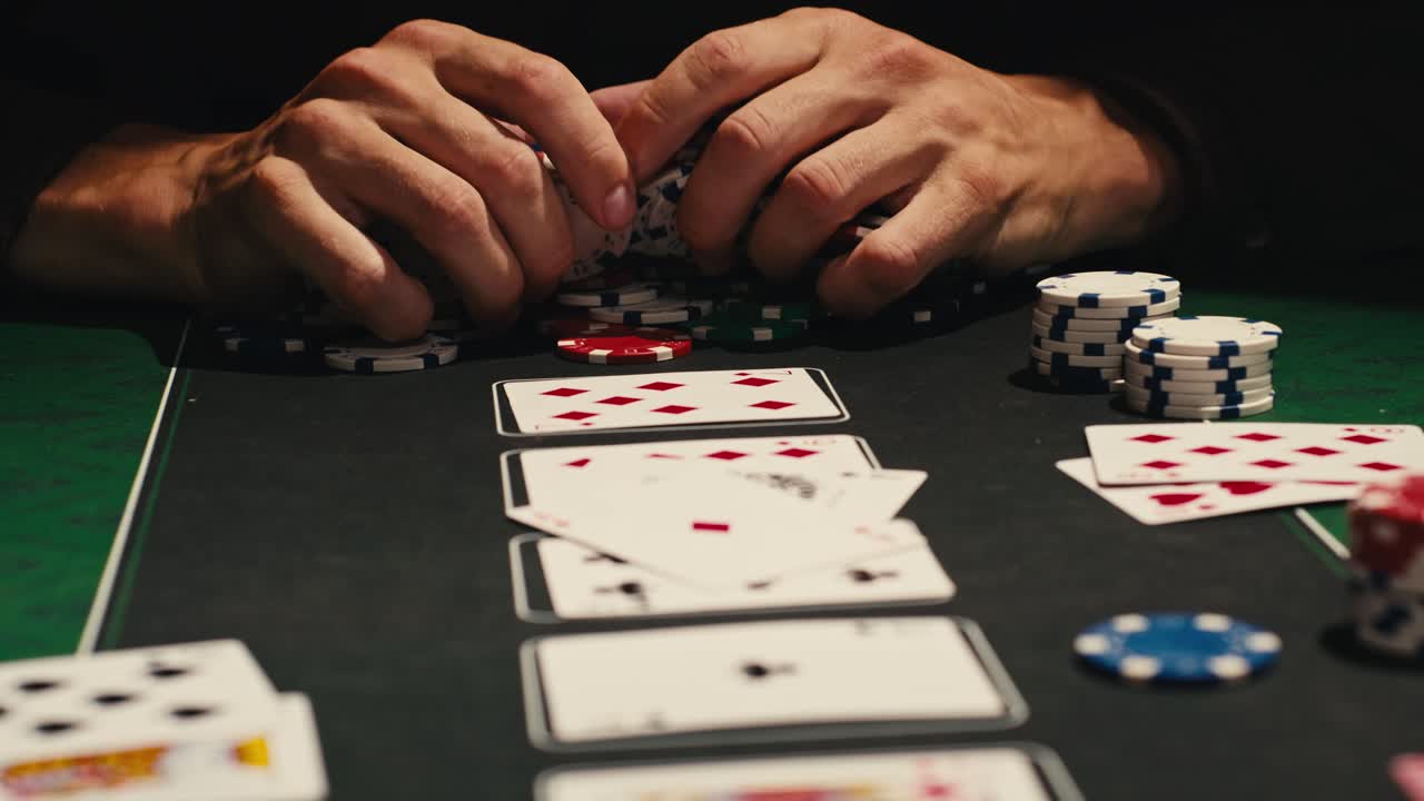 Hands managing poker chips on green table, reflecting intense poker gameplay with the element of chance and skill