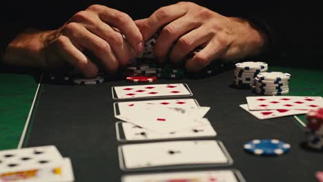 hands managing poker chips on green table, reflecting intense poker gameplay with the element of chance and skill
