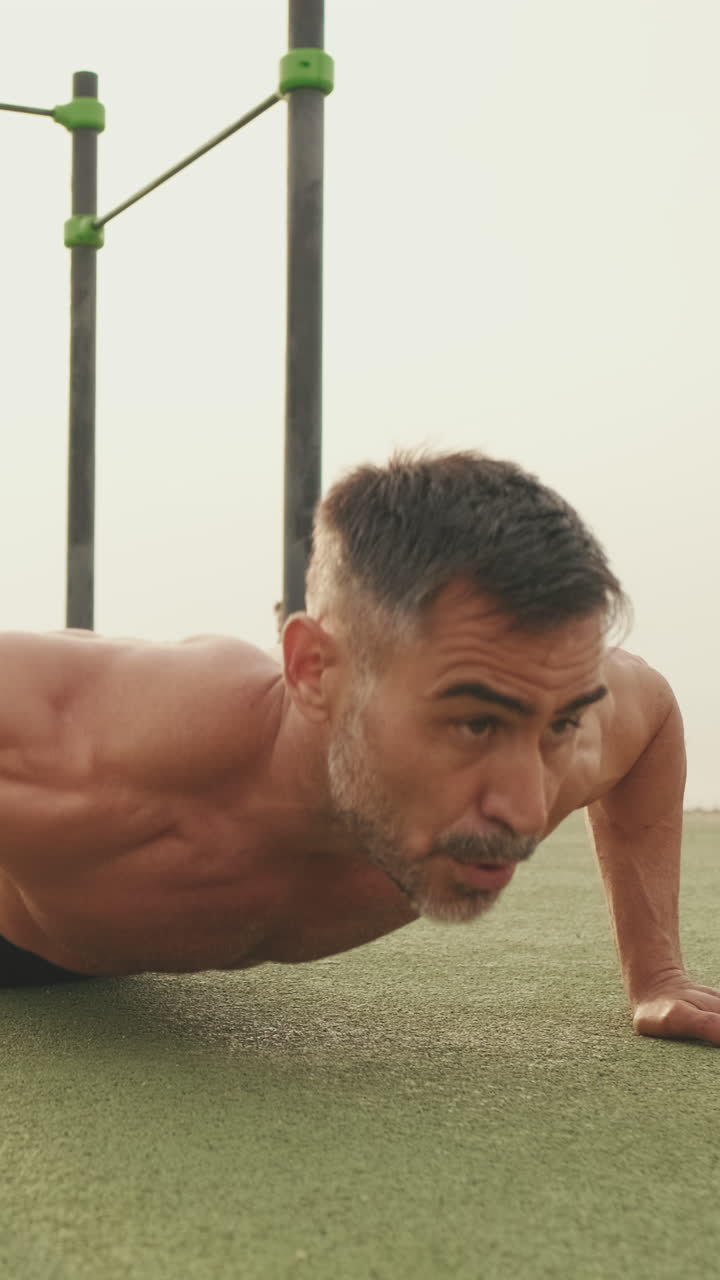 Man doing push ups in an outdoor workout area