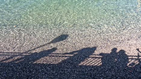 shadows of people by lake como