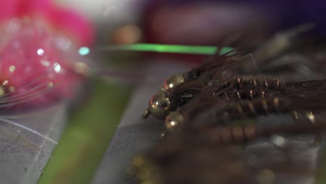 Acercar-La-Captura-Macro-De-Trucha-De-Pesca-Con-Mosca-Húmeda-Atada-A-Mano-Y-Moscas-De-Ninfa-De-Salmón