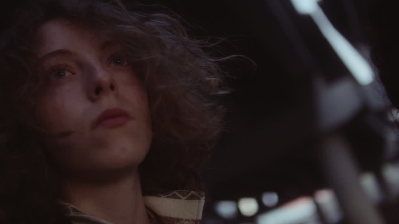 Close-up portraits of women in a dark, low-light setting