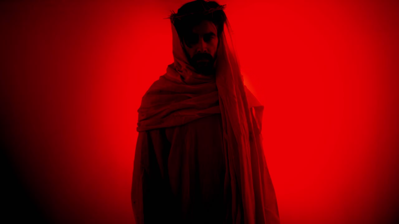 Jesus Christ offering his hand, wearing crown of thorns for Christianity, Easter visual, bible scene or temptation, prayer, worship visual.